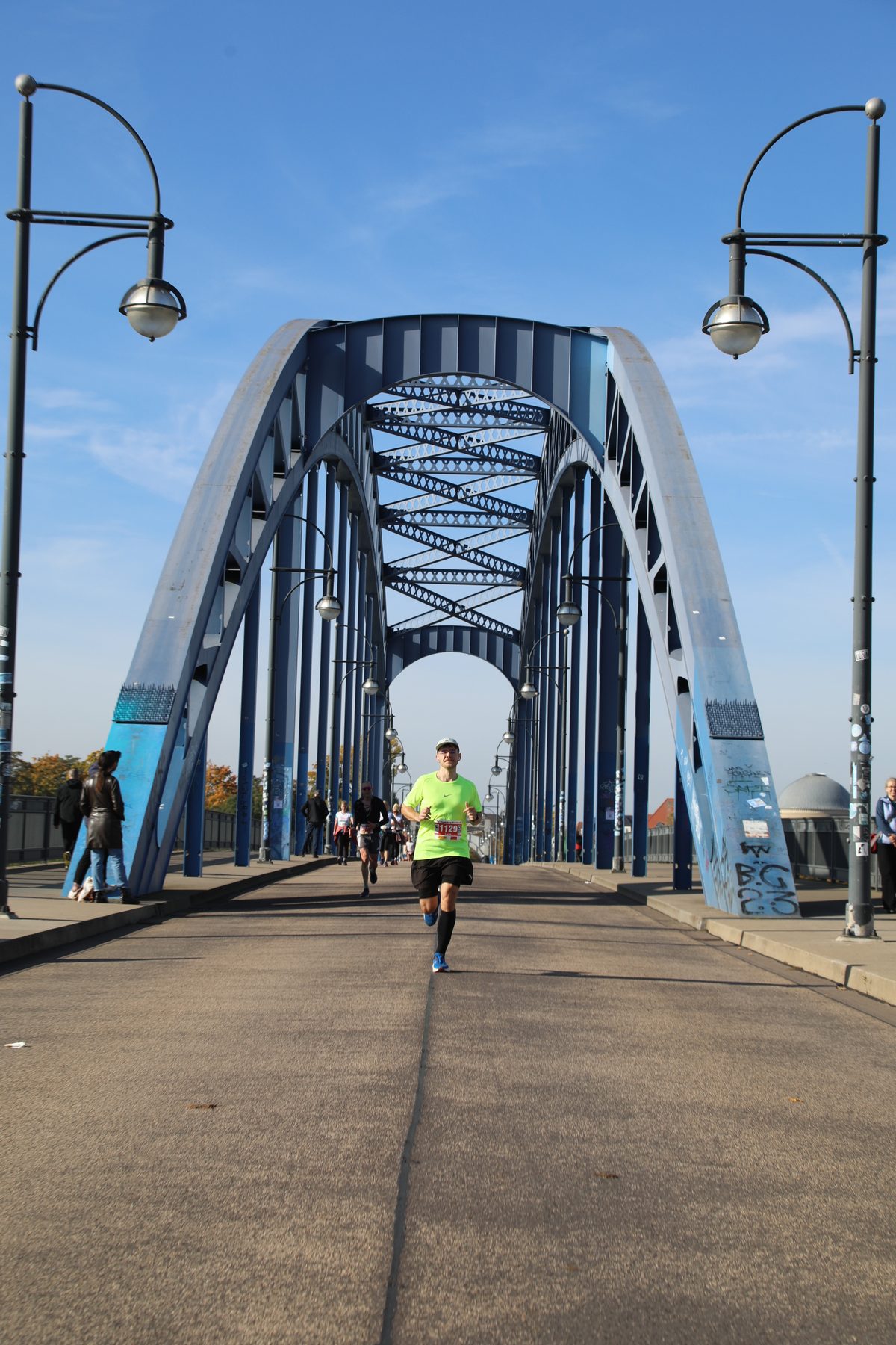 Lucas läuft im Morgenlicht allein über die blaue Sternbrücke in Magdeburg